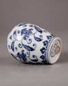 A Chinese blue and white jar with a copper oil lamp cover