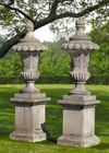 A PAIR SCULPTED LIMESTONE GARDEN VASES ON TALL PEDESTALS, 20TH CENTURY