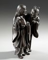 A FINE JAPANESE BRONZE OBJECT 置物 DEPICTING KANZAN 寒山 (HANSHAN) AND JITTOKU 拾得 (SHIDE), MEIJI PERIOD (1868-1912)