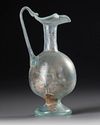 A ROMAN PALE GREEN GLASS EWER, CIRCA 1ST–3RD CENTURY A.D.