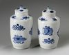 A pair of small Chinese blue and white vases and covers
