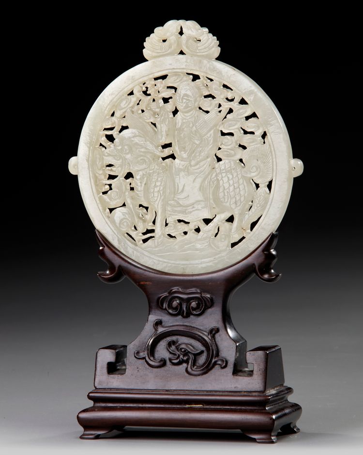A CHINESE WHITE JADE ARCHAISTIC OPENWORK PLAQUE ON A WOODEN STAND, 19TH-20TH CENTURY