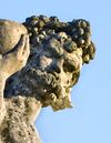 A MONUMENTAL AND IMPRESSIVE ITALIAN SCULPTED LIMESTONE GROUP OF BACCHUS WITH A SATYR,  FIRST QUARTER 20TH CENTURY