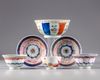 A Chinese famille rose group of three cups, two saucers, a bowl and a dish