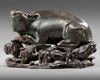 A CHINESE BRONZE BUFFALO ON A STAND, MING DYNASTY (1368-1644)