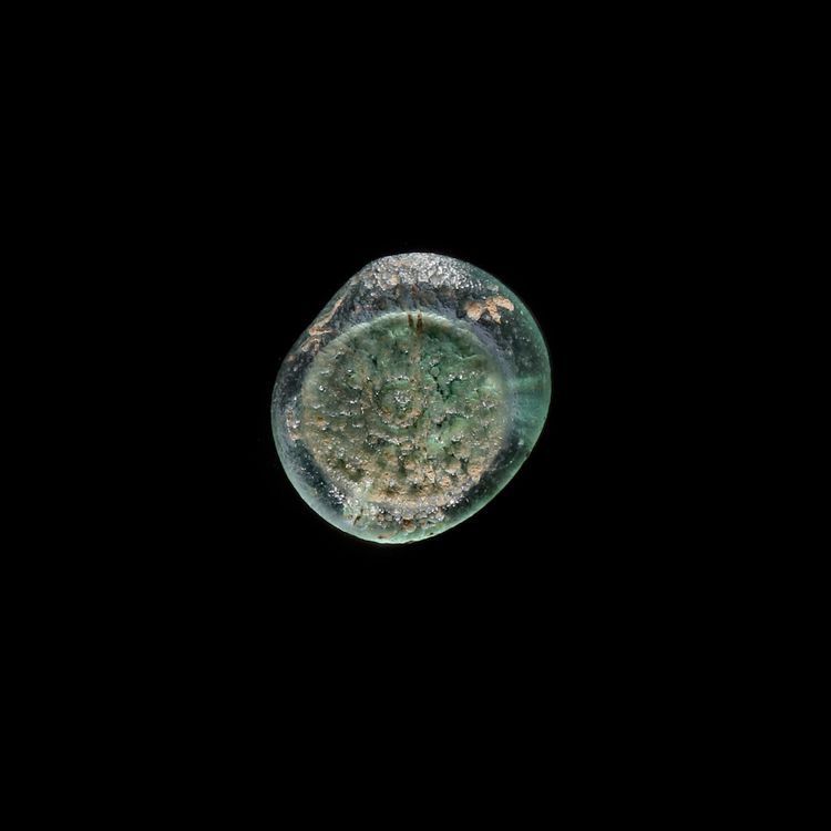 A FATIMID GLASS WEIGHT OF QUARTER DINAR, EGYPT AL-HAKIM BI-AMR ALLAH (386AH-411AH/ 996AD-1021AD)