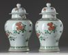 A pair of Chinese famille verte 'pheasants and peony' vases and covers