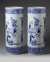 A pair of large blue and white umbrella stands