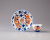 A small Chinese iron-red-decorated blue and white 'dragon' cup and saucer