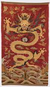 A Chinese red-ground kesi 'dragon' panel