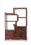 A small Chinese hardwood ‘dragon’ display cabinet