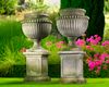 A PAIR OF LARGE AND IMPRESSIVE CARVED LIMESTONE GARDEN URNS ON PLINTHS IN IMPERIO TASTE, LATE 20TH CENTURY