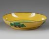 A SMALL CHINESE YELLOW GLAZED PLATE WITH DRAGONS, 19TH-20TH CENTURY