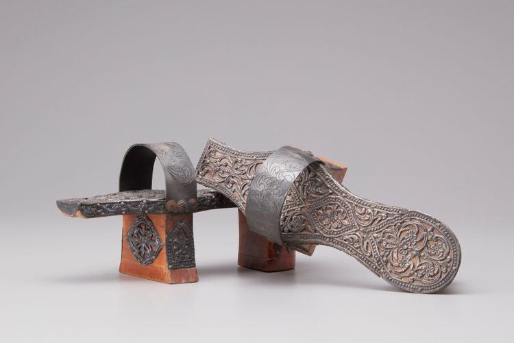 A pair of wood and silver hammam shoes