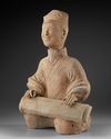 A RARE TERRACOTTA  STATUE OF A SITTING MUSICIAN PLAYING A ZITHER TYPE INSTRUMENT, CHINA, EASTERN HAN DYNASTY (25-220 AD)