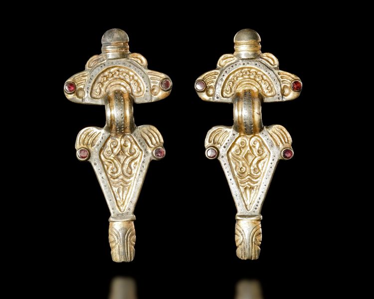 A PAIR OF THURINGIAN GILT SILVER RADIATE-HEADED BROOCHES, 5TH-6TH CENTURY AD