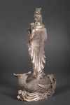 A METAL SCULPTURE OF GUANYIN STANDING ON A FISH, 20TH CENTURY