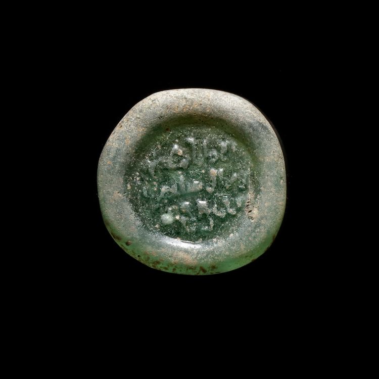 A FATIMID GLASS WEIGHT OF DOUBLE DIRHAM , AL-MUSTANSIR BI-ALLAH (AH 427-487 / 1036-1094 AD)