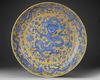 A LARGE CHINESE BLUE-ENAMELED AND YELLOW-GROUND 'DRAGON' CHARGER