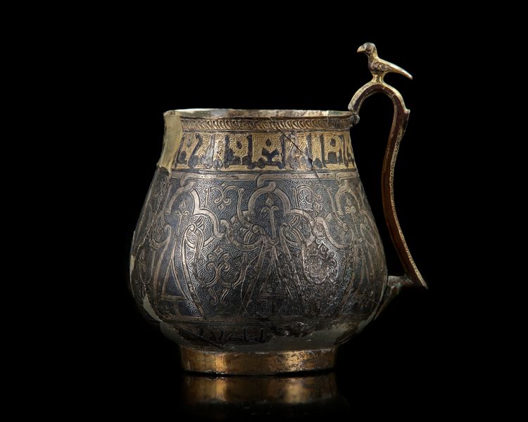 A VERY RARE AND IMPORTANT EARLY ISLAMIC PARCEL-GILT CUP