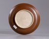 A Chinese café-au-lait glazed anhua decorated dragon dish