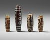 A group of four Tibetan dzi beads