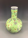 A Chinese green-ground famille rose appliqué decorated bottle vase
