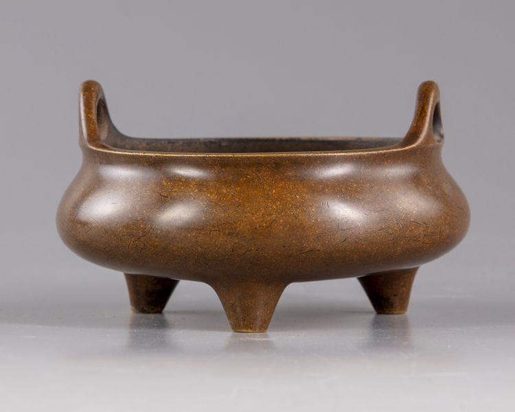 A Chinese bronze tripod censer