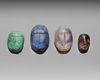 A GROUP OF FOUR HARD STONE SCARABS, CIRCA 1500-500 B.C.