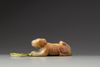 A celadon and russet jade carving of a hound