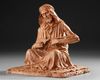 A TERRACOTTA SCULPTURE DEPICTING AN ARAB MAN
