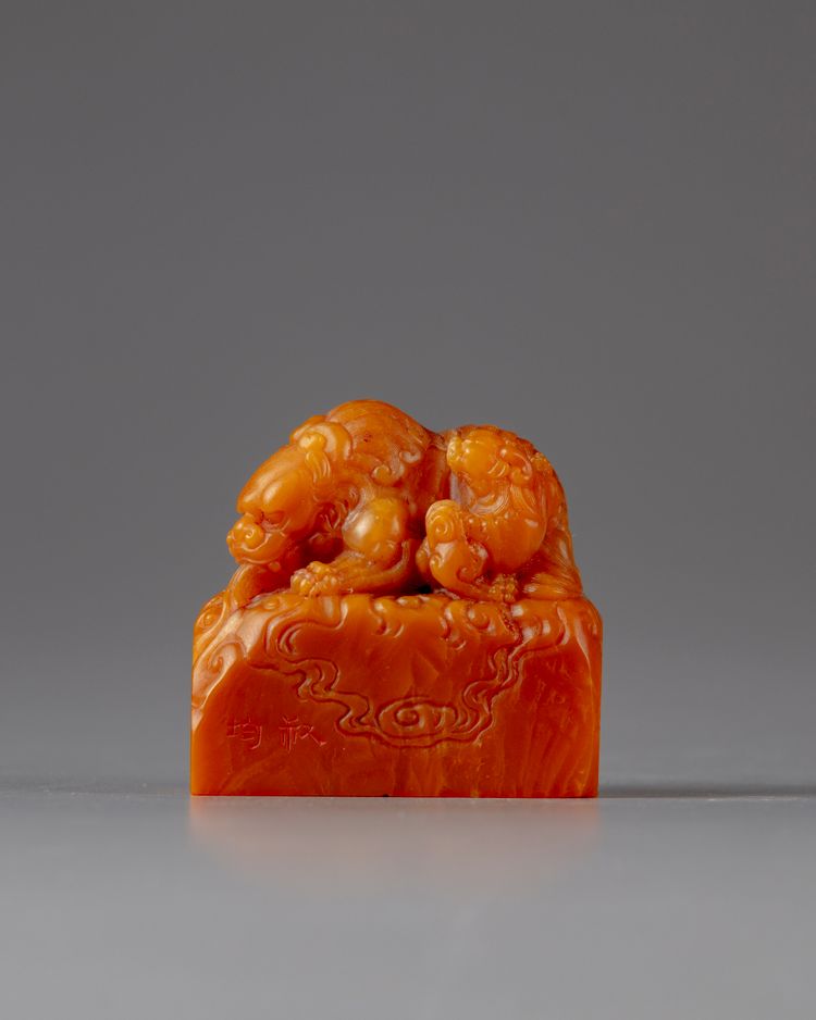 A soapstone seal carving of a fu lion and cub