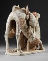 A PAINTED TERRACOTTA KNEELING CAMEL WITH SADDLE PACK, CHINA, TANG DYNASTY (618-906 AD)