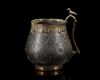 A VERY RARE AND IMPORTANT EARLY ISLAMIC PARCEL-GILT CUP