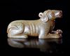 A CHINESE JADE OF A RECLINING DOG, HAN DYNASTY (206 BC–220 AD)