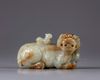 A CHINESE CELADON AND RUSSET JADE BUDDHIST LION WATER DROPPER, CHINA, QING DYNASTY (1644-1911)