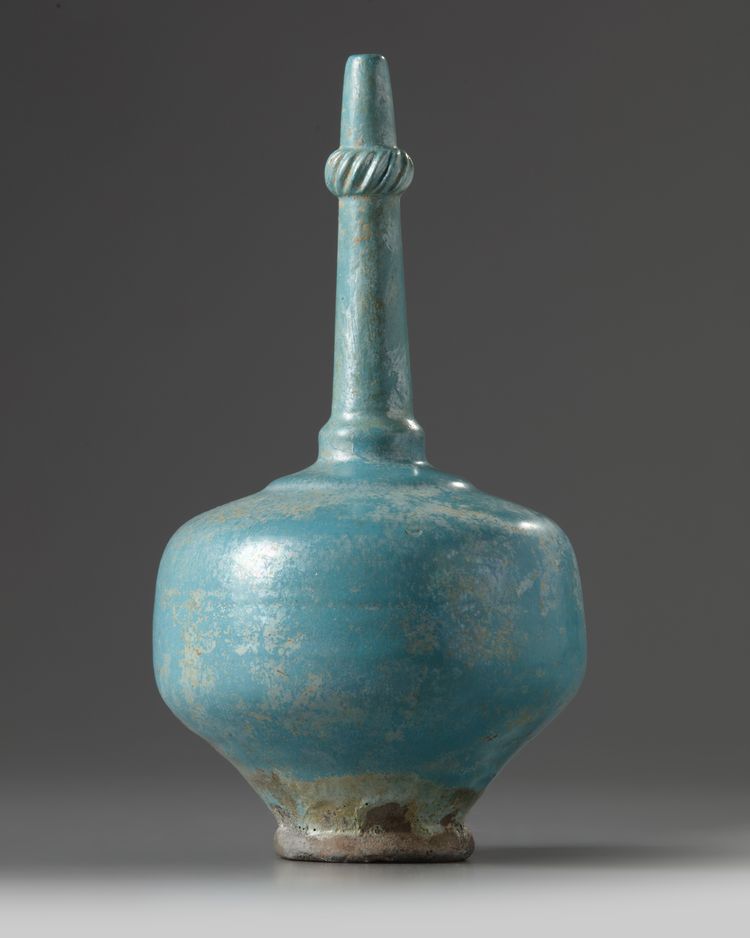 An Islamic turquoise glazed bottle vase