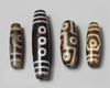 A group of four Tibetan dzi beads
