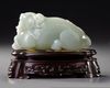 A CHINESE CELADON JADE CARVING OF A WATER BUFFALO GROUP, 19TH-20TH CENTURY