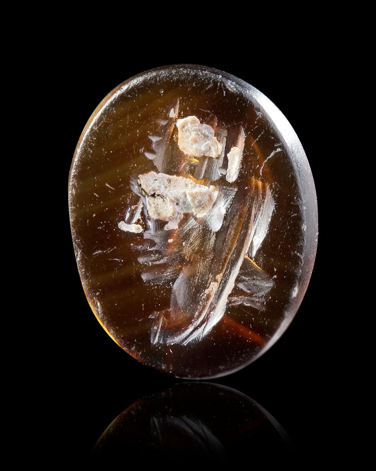 A DARK AGATE INTAGLIO, WITH HEAD OF TYCHE, 1ST CENTURY AD