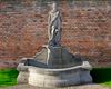 A SCULPTED LIMESTONE FIGURAL WALL FOUNTAIN, SECOND HALF 20TH CENTURY