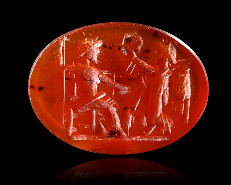 A CARNELIAN INTAGLIO SHOWING JUPITER SEATED WITH VICTORY, 2ND-3RD CENTURY AD