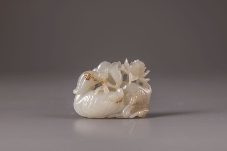 A white and russet jade 'mandarin ducks and lotus' carving