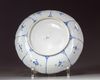 A CHINESE BLUE AND WHITE BARBED RIM 'FLOWER BASKET' DISH, 17TH CENTURY