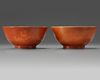 A pair of Chinese coral-ground gilt-decorated bowls