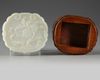 A Chinese pale celadon jade 'peach' plaque on a hongmu box