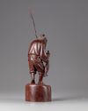 A Chinese hardwood carving of a fisherman