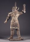 A LARGE CHINESE POTTERY GUARDIAN KING, EARLY TANG DYNASTY, MID 7TH CENTURY