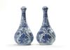 A pair of Chinese moulded blue and white 'Kraak' garlic neck vases