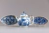 A Chinese blue and white teapot and two oval shaped trays
